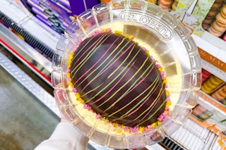hand holding up a junior's easter egg cake at costco