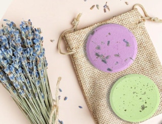 two showers steamers on a burlap sack next to a bunch of flowers