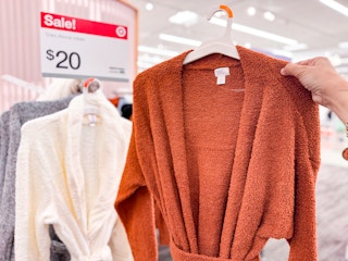 Stars Above Cozy Yarn Robe held up in front of Target sale sign