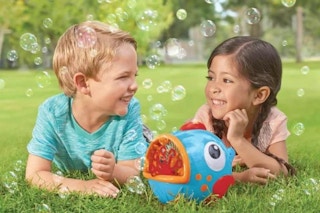 lifestyle image of children playing with a bubble blower