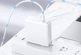 a laptop charger plugged into a power strip