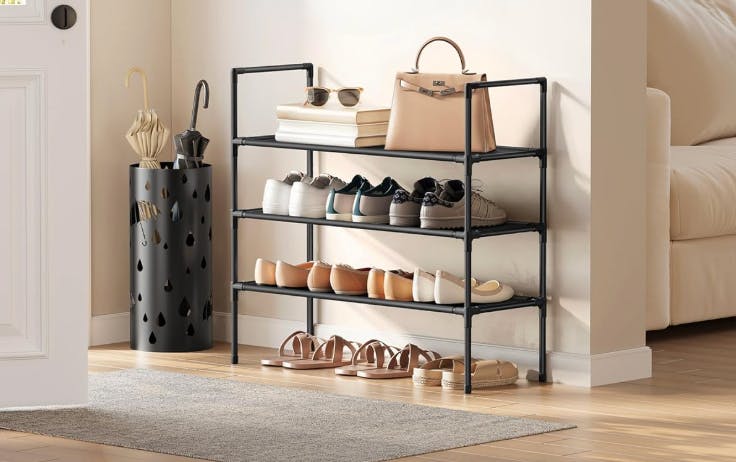 a shoe rack with shoes and a purse next to a door