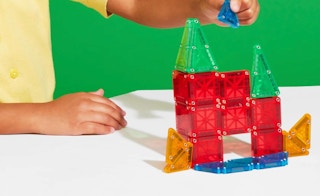 a person putting together a tile set