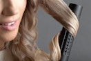 Woman curling her hair.