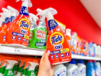hand holding tide laundry stain remover in front of a target shelf