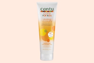 a tube of hair product on a light peach background