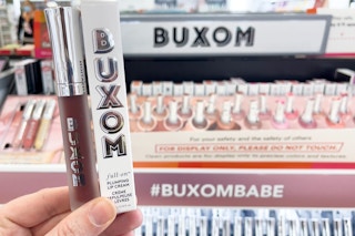 buxom plumping lip cream being held in ulta store 