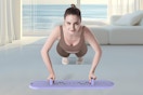 a woman using a reformer board