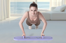 a woman using a reformer board