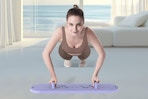 a woman using a reformer board