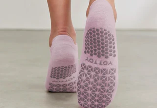 pink pilates socks on someone's feet while they're walking