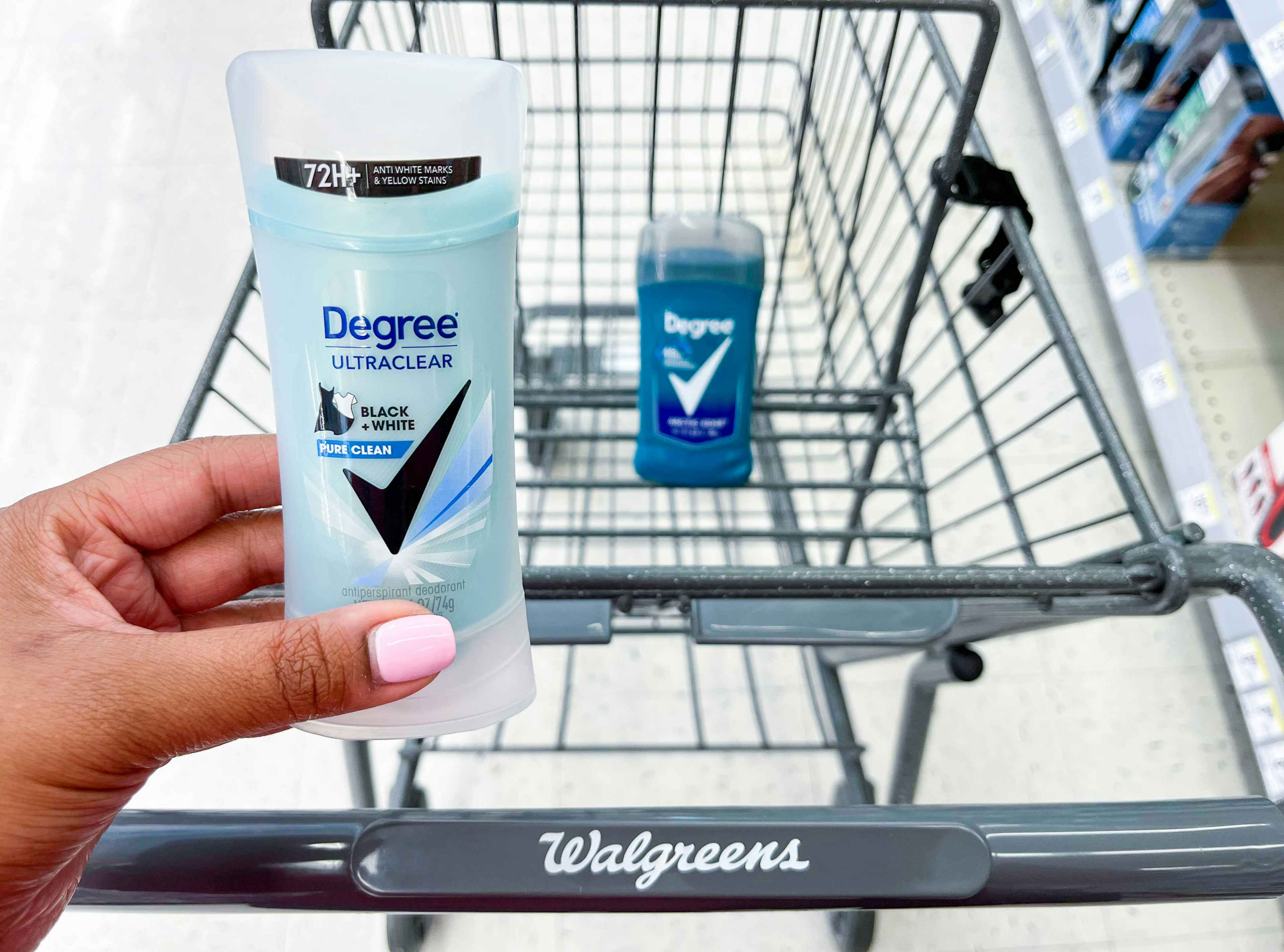 hand holding one Degree deodorant in front of shopping cart with another Degree deodorant inside cart