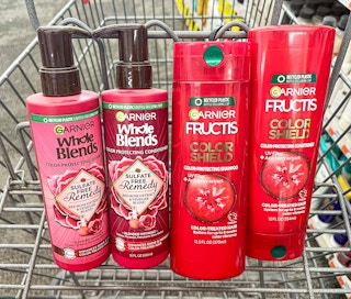 two bottles of Garnier Whole Blends and two bottles of Garnier Fructis shampoo and conditioner inside shopping cart