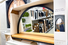 threshold mirror with shelf and hooks sitting on a target shelf