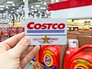 Someone holding their Costco Gold Star Member card inside Costco