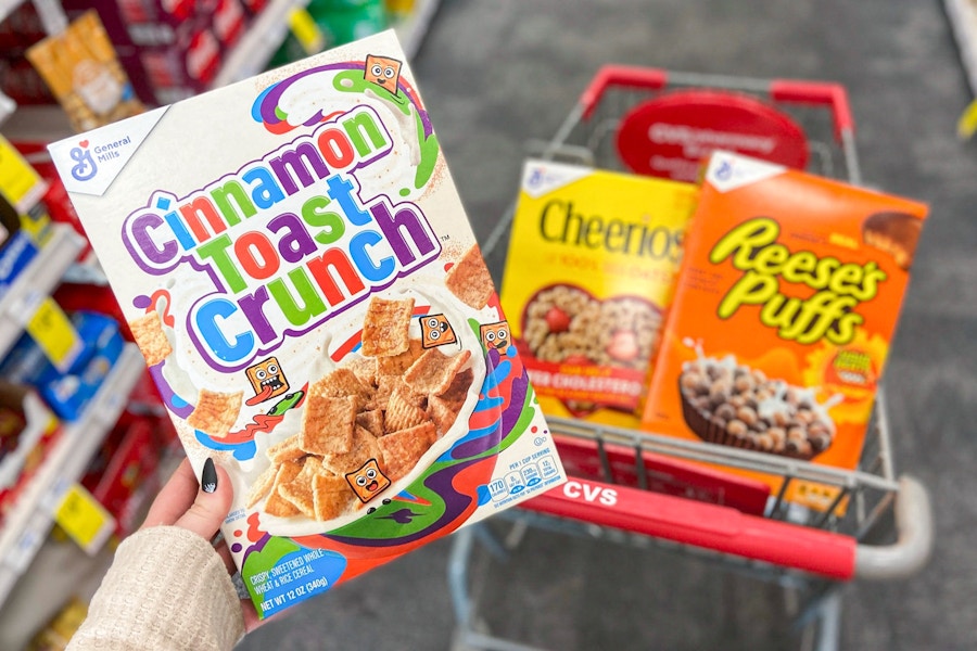 Three boxes of General Mills cereal in a cart at CVS