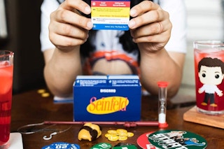 A woman playing the Seinfeld Funko game