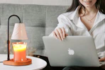 a woman using a candle warmer lamp