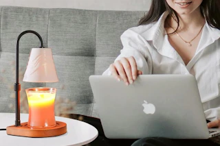 a woman using a candle warmer lamp
