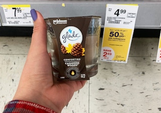 Glade candle next to a yellow sale tag indicating BOGO 50% off sale through May 29