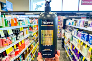 hand holding tresemme shampoo in cvs