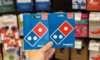 hand holding two Domino's gift cards