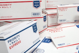 Many USPS Priority Mail packages piled together