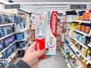 hand holding colgate oral care products in walgreens