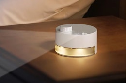 Portable White Noise Machine: 24 Soothing Sounds on a nightstand.