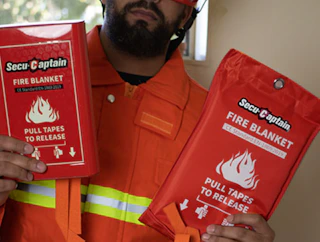 a person holding emergency fire blanket packs