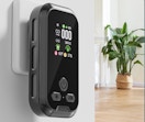 a carbon monoxide detector plugged into a wall in a house