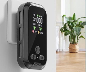 a carbon monoxide detector plugged into a wall in a house