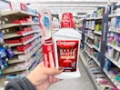 hand holding colgate products in walgreens