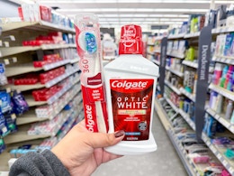 hand holding colgate products in walgreens