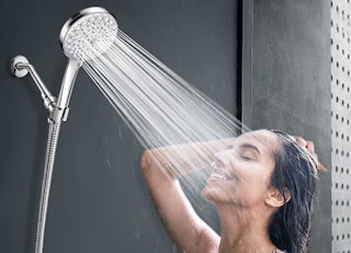 A woman using the shower head