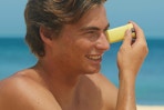 a man applying a sunscreen stick