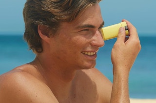 a man applying a sunscreen stick