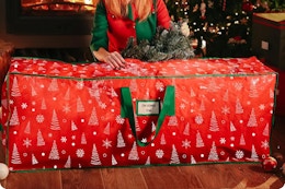 a woman using a christmas tree bag