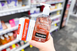 hand holding neutrogena acne care cleansers at cvs