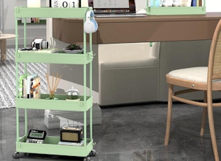 a green storage cart in a room with items next to a desk