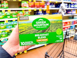 hand holding a box of green mountain k-cups