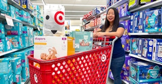 someone shopping for baby stuff at Target, pushing a cart full of products