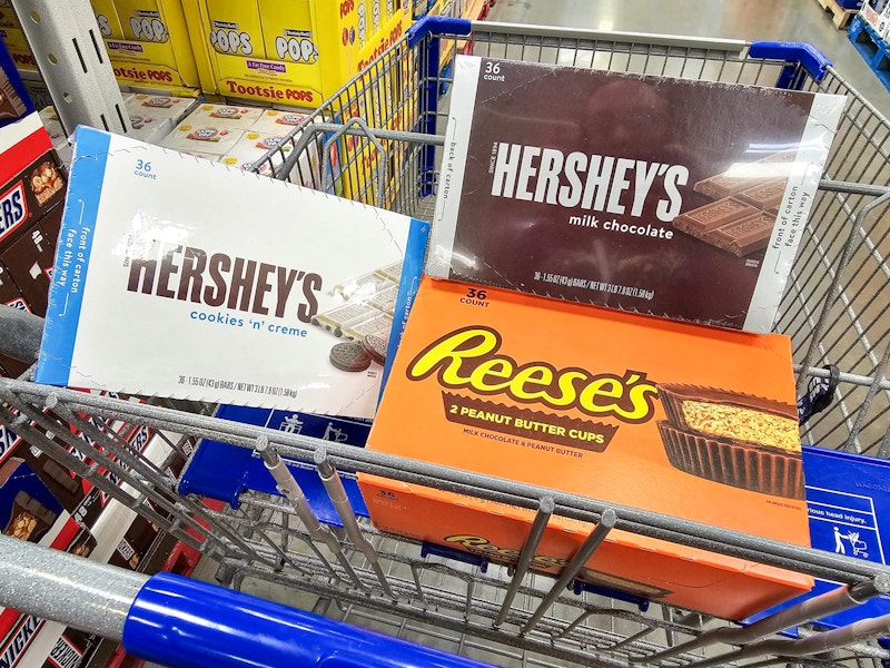 boxes of hersheys and reeses candy bars in a cart