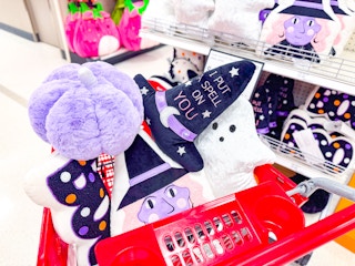 halloween throw pillows sitting in a target cart