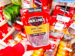 hand holding a jack link's beef jerky bag in front of target sale signage