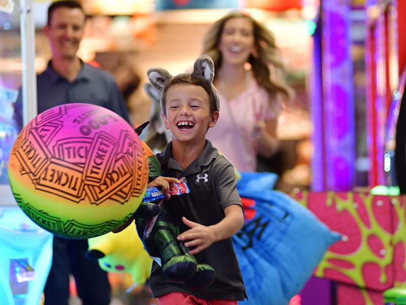 Child carrying toys in an arcade at Great Wolf Lodge