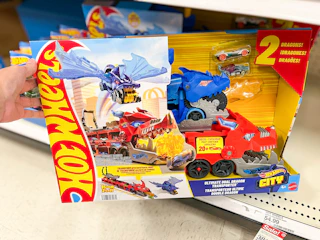 hand grabbing a hot wheels dual dragon transporter off a target shelf