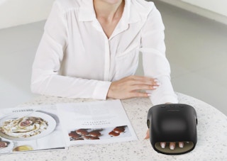 a person sitting with their hand in a hand nassager