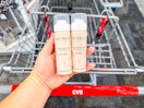 hand holding nexxus dry shampoo over a cvs cart