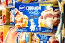 hand holding a box of pillsbury cinnamon rolls